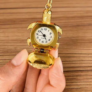 Close-up detail of the cute gold turtle pocket watch featuring quartz movement and open flip cover.