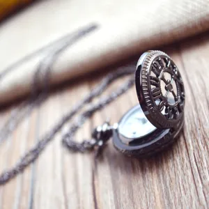 Vintage hollow quartz pocket watch with long chain, antique gunmetal finish, unisex accessory