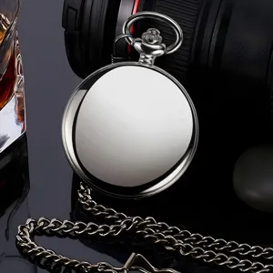 Detail view of a classic silver quartz pocket watch with metallic chain on dark background.