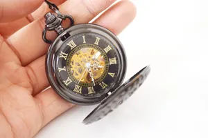 Classic vintage mechanical pocket watch with skeleton dial, black case and metal chain.