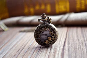 Vintage bronze hollow gear quartz pocket watch with sweater chain for daily casual wear.