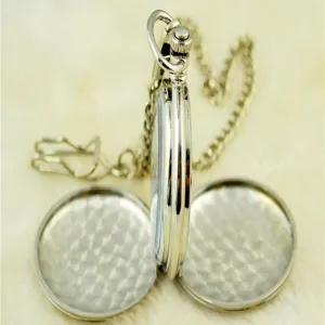 Vintage silver mechanical pocket watch detail shot with double open covers and chain