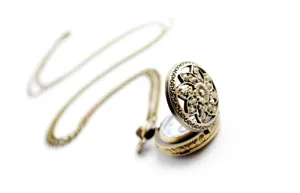 Vintage bronze pocket watch with hollow floral carved cover and long matching chain.