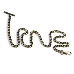 Detailed shot of vintage bronze pocket watch chain with T-bar and clasp, sturdy metal.
