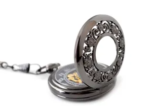 Detailed view of hollow carved floral pocket watch lid, vintage mechanical design, gunmetal finish.