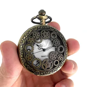 Vintage bronze tone mechanical gear pocket watch detail view showcasing intricate hollow design.