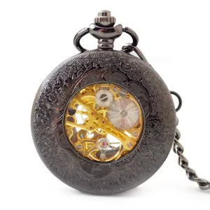 Vintage black mechanical pocket watch with hollow floral carved case and golden gear movement.