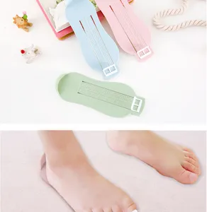 Detailed view of infant foot measuring ruler with clear scale markings for kids shoe sizing.