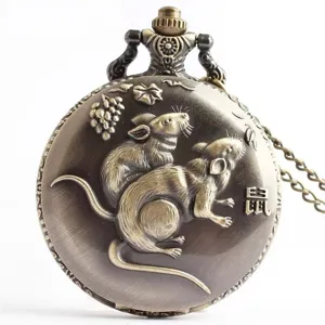 Close-up view of vintage bronze pocket watch featuring detailed zodiac rat and grape relief.