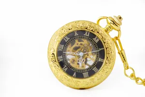 Detailed view of a vintage gold mechanical pocket watch with hollow dial and chain.