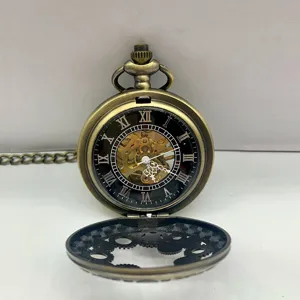 Close-up detail of the vintage bronze mechanical pocket watch with skeleton gear dial and chain.