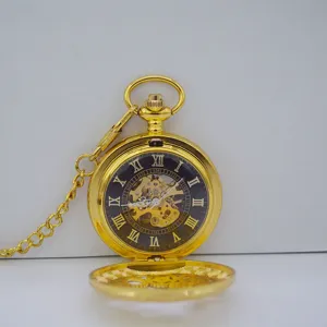 Detailed view of the vintage gold mechanical pocket watch with black dial and skeleton gear.