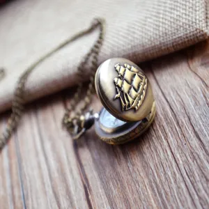 Vintage bronze sailboat pocket watch with chain, classic quartz timepiece for men and women.