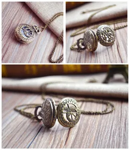 Vintage bronze pocket watch detail shot, intricate astrolabe and zodiac engravings on metal case.