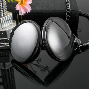 Close-up detail of smooth black double cover quartz pocket watch with matching chain decor.