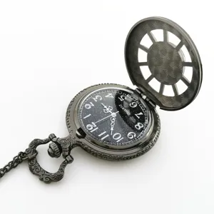 Vintage quartz pocket watch with starry dial and chain, antique metallic finish detail.