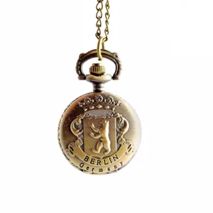 Vintage bronze quartz pocket watch with chain, classic bear coat of arms design for daily wear.