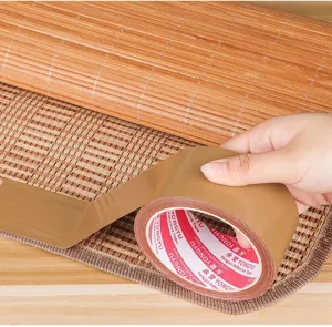 Close-up detail of brown repair tape for bamboo mats, showing strong adhesive backing and texture.