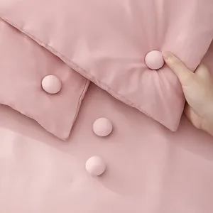 Pink duvet cover set with cute spherical quilt clips fasteners, soft and cozy bedding decor.
