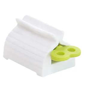 Manual plastic toothpaste squeezer dispenser with creative green key design for bathroom use