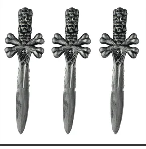 Plastic pirate dagger detail showing skull handle and crossbones guard Halloween toy prop.