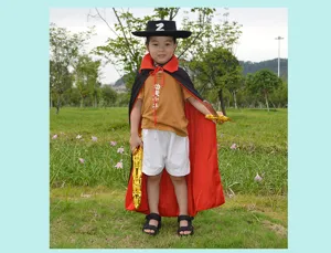 Details of kids Zorro cosplay costume featuring black Z hat, red cape, and golden toy swords.