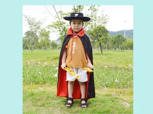 Detailed view of children costume set featuring black cape, yellow t-shirt and toy swords.