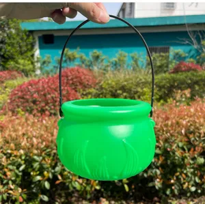 Green plastic witch cauldron bucket with black handle for St. Patrick's Day party decor.
