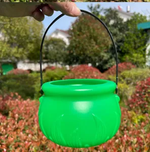 Green plastic cauldron bucket with black handle for St Patrick Day party decoration