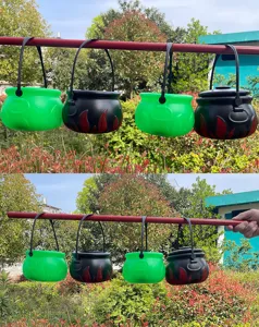 St. Patricks Day green witch cauldron flame bucket plastic decoration detail shot outdoor display.