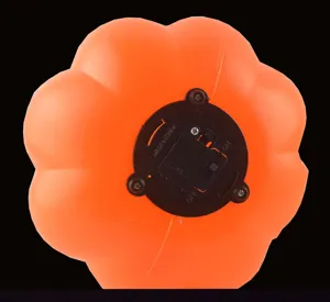 Detail view of the orange plastic Halloween pumpkin lamp bottom battery compartment.