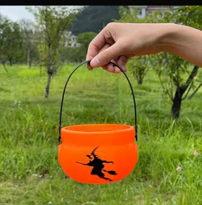 Halloween witch candy bucket detail view, lightweight orange plastic trick or treat container.