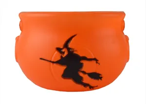 Halloween orange witch cauldron candy bucket with black silhouette for party decor detail shot.
