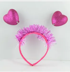 Pink glitter heart headband with springs and tinsel details for party wear and styling.