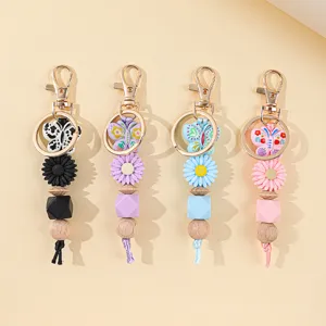 Detailed set of silicone bead keychains featuring butterfly charms and daisy beads in pastels
