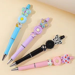 Detailed view of colorful beaded pens featuring butterfly and daisy silicone beads