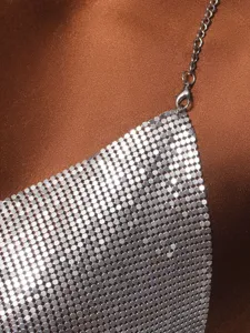 Close-up view showing the intricate silver metallic mesh and chain strap of a halter top