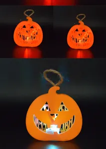 Halloween glowing pumpkin lantern detail, cutout design with warm LED light and hanging rope.