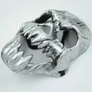 Detailed close-up shot of the silver scary skull mask with sharp teeth and black tactical strap.