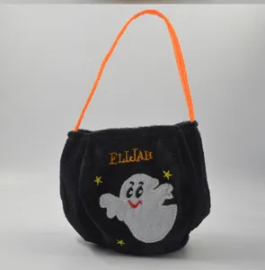 Black plush Halloween trick or treat candy bag with cute ghost embroidery and orange handle.