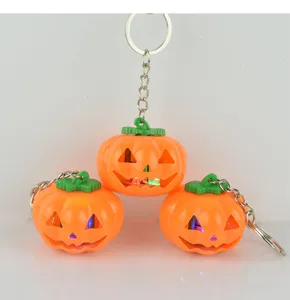 LED glowing pumpkin keychain detail, Halloween spooky pendant decor, flashing light accessory.