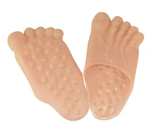 Close-up detail of funny flesh-colored simulation giant foot slippers, realistic design.
