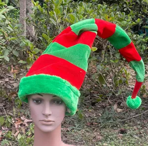 Close-up view of a long red and green striped Christmas elf hat in outdoor natural scene.