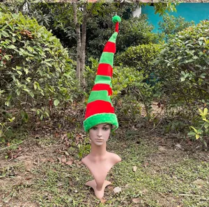 Outdoor display detail of a long red and green striped plush Christmas elf hat prop.