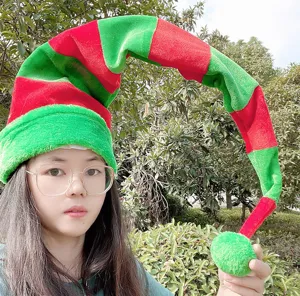 Close-up detail of the extra long red and green striped plush Christmas elf hat worn outdoors.
