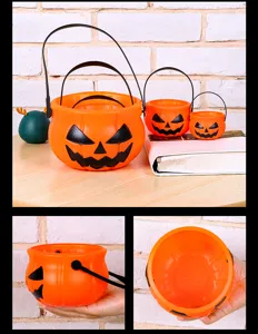 Close-up details of Halloween pumpkin candy buckets, showing multiple sizes, interior and hand.