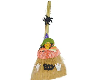Halloween witch broom detail shot featuring cute doll and ghost spooky decoration.