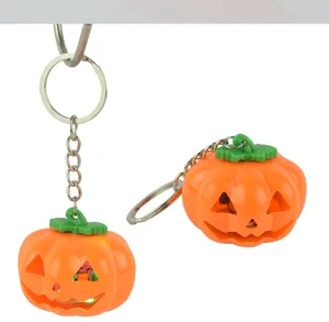 Close-up detail view of the glowing LED pumpkin keychain featuring orange plastic shell.
