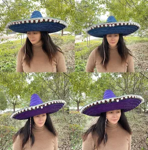 Detailed close-up view of Mexican straw hat, pointed festive woven hat with colorful decor.