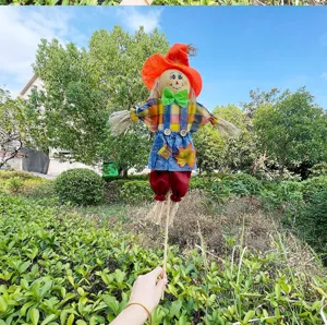Handcrafted straw scarecrow doll autumn harvest decoration for garden party and holiday decor.